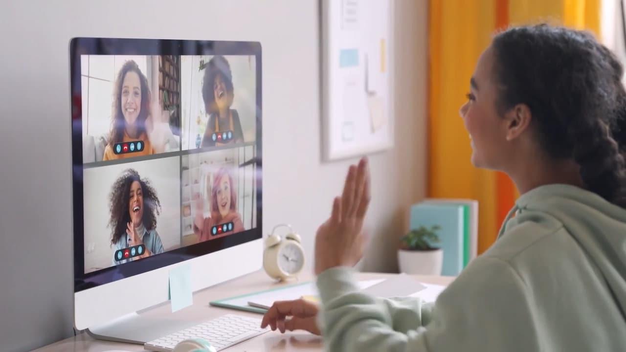 Connections Academy student waving to students and teachers on a video call