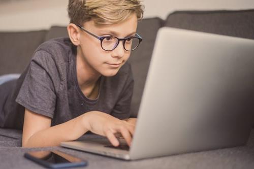 Homeschool student learns computer coding skills. 